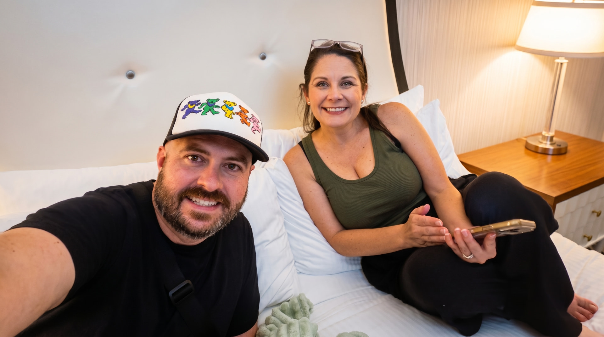 Chad and his wife relaxing together on a bed