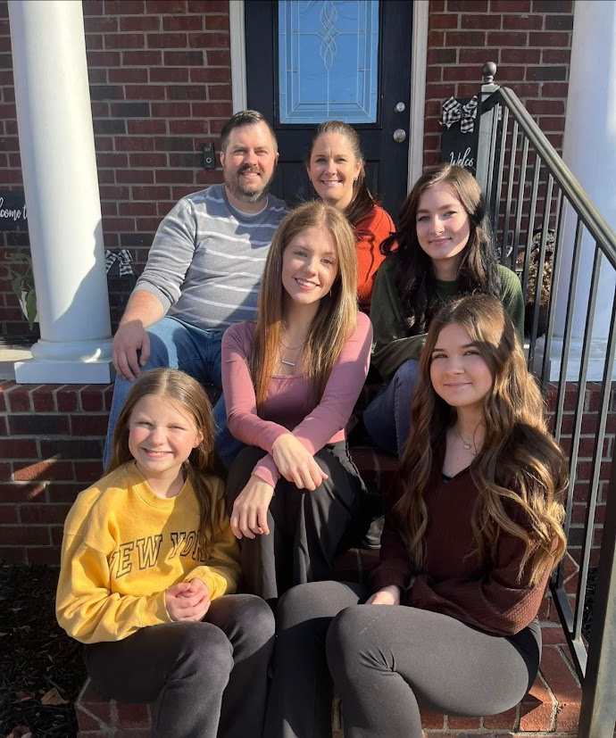 Chad Sheppard with his family on the front steps of their home